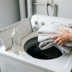 Freshly washed towels being sniffed by the washing machine because towels smell after washing
